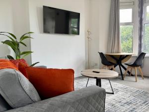a living room with a couch and a table at City Centre Embankment Apartments Superb Location in Cardiff