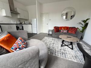 a living room with a couch and a table at City Centre Embankment Apartments Superb Location in Cardiff