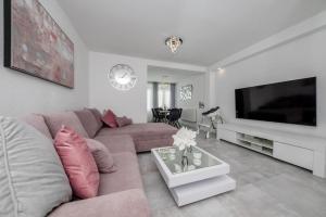 a living room with a couch and a tv at Apartmani Mery in Rab
