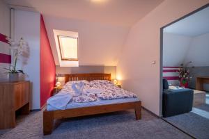 A bed or beds in a room at Penzion Raj