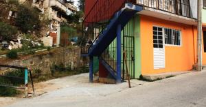 a building with a slide on the side of it at Cozy family apartment, kitchen in Mineral del Monte +5 photos
