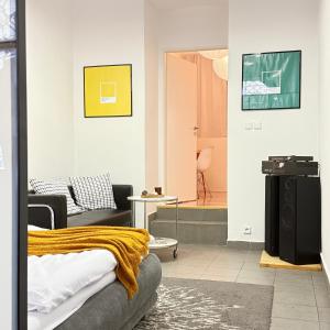a living room with a couch and a tv in a room at The Rest Point Prague in Prague