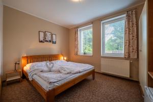 A bed or beds in a room at Penzion Raj