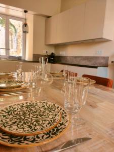 a table with glasses and plates on top of it at La Marquise des Anges in Martel +22 photos