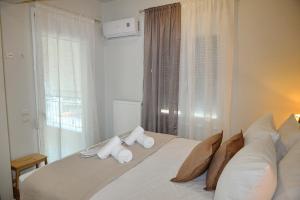 a bedroom with a bed with two towels on it at Viewpoint apartment chalkis in Chalkida