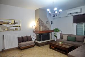 a living room with a couch and a fireplace at Viewpoint apartment chalkis in Chalkida