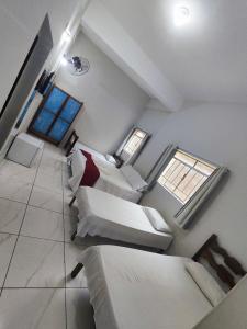 a living room with a couch and two windows at Sinhá Moça Diamantina-MG in Diamantina