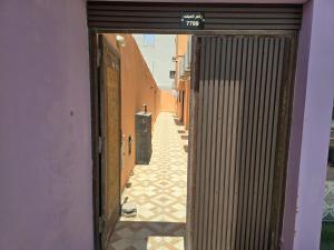 an open door to a hallway with a tile floor at hajer221 in Al Hofuf