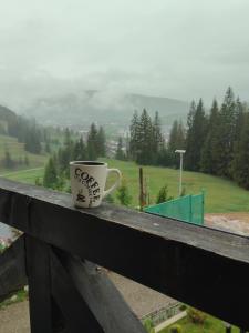 una taza de café sobre una barra de madera en Bucovina Sky View, en Gura Humorului