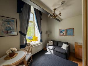 a living room with a couch and a table at Loft Kalamaja in Tallinn