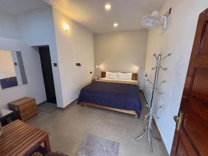 a bedroom with a bed with a blue bedspread at Kubera Heritage Inn , Near Sreepadmanabhaswamy temple in Trivandrum