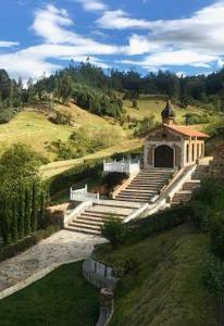 a building with a bunch of steps in a field at Villa Germana in Paipa