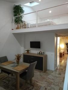 a living room with a loft bed and a table at BRISAS VIP Tesoro in Valencina de la Concepción