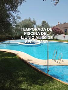 a sign in front of a swimming pool at BRISAS VIP Tesoro in Valencina de la Concepción +5 photos