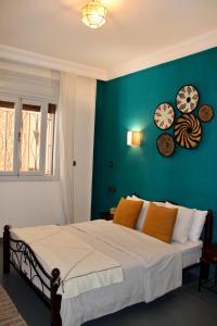 a bedroom with a bed with a blue wall at Seaside 2 Bedrooms Villa - IMI OUADDAR in Agadir +52 photos