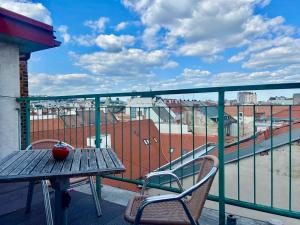 a table and chairs on a balcony with a view at Oldtown Magic Cityhub in Bratislava +15 photos