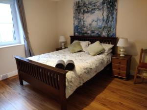a bedroom with a bed with shoes on it at Avondale Apartment Lahinch in Lahinch