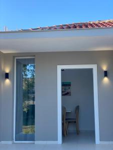 a sliding glass door to a patio with a table at Villa Oliver in Hamallë
