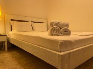 a bedroom with a bed with towels on it at Samothraki Therma Noula Rooms in Samothraki +5 photos