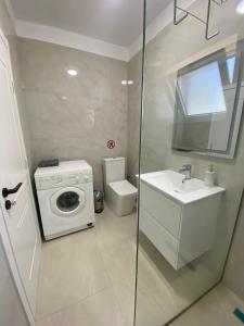 a bathroom with a washing machine and a sink at Villa Oliver in Hamallë +9 photos