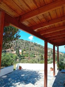 a wooden pergola with a view of a mountain at Κυκλαδίτικο διαμέρισμα in Andros