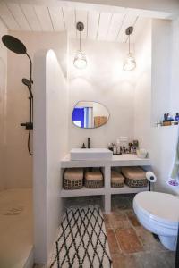 a bathroom with a sink and a toilet and a mirror at Le Clos Saint-Sif, 4 BR, air conditioning, pool in Saint-Siffret