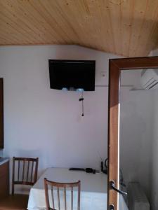 a room with a bed and a tv on a wall at Apartment Anastazija in Nin