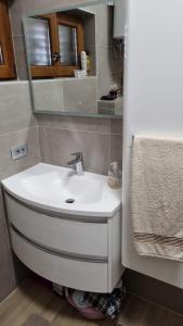 a bathroom with a white sink and a mirror at Apartment Anastazija in Nin +19 photos
