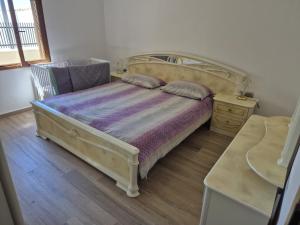 a bedroom with a bed and a chair and a table at Apartment Anastazija in Nin
