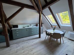 a kitchen with a table and chairs in a room at Kastélykert Vendégház Tata in Tata