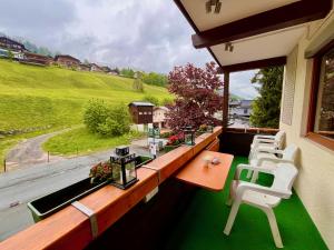 a balcony with a table and chairs and a view at 3-Room Apartment with sauna and pool & walk to slopes - JokerCard included in Saalbach Hinterglemm