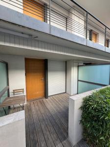a building with a wooden deck with a bench on it at 014 Studio Provençal - Proche d'Aix en Provence in Éguilles