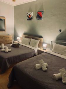 a bedroom with two beds with towels on them at Villa Palma in Alexandroupoli