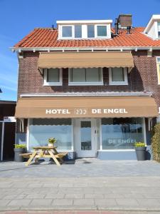 a store with a table in front of a building at Hotel Restaurant de Engel in Lisse