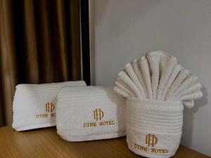 two towels sitting on a table in a hotel room at Dine Hotel in Ksamil