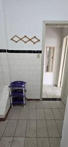 een betegelde badkamer met een paarse bank in een kamer bij Vista incrível para o mar! in Santos