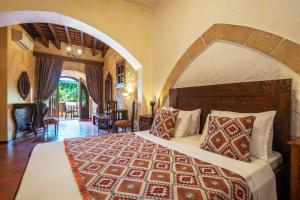 a bedroom with a large bed in a room at S.Nikolis' Historic Boutique Hotel in Rhodes Town