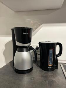 two black and white coffee makers sitting on a counter at Gemütliches Appartement in Bad Rothenfelde in Bad Rothenfelde