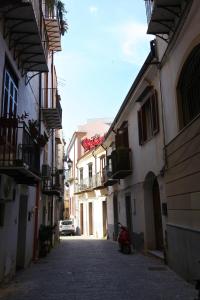 an alley with buildings and a scooter on a street at Centro storico apartment & Loft - Amnesia Holiday Home in Palermo