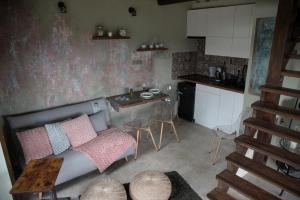 a living room with a couch and a table at KisHáz a Zselicben in Zselickisfalud