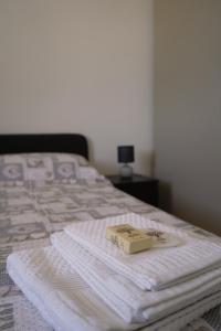 a book sitting on top of a bed at Casa Marisa Design by the Sea in Torre Saracena