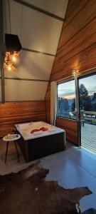 a room with a bed and a large window at Cabana Santa Cruz 2 in São Francisco de Paula