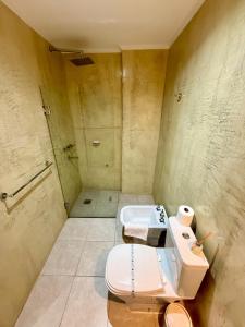 a bathroom with a toilet and a sink at Departamento con Vista al Río in Posadas +16 photos