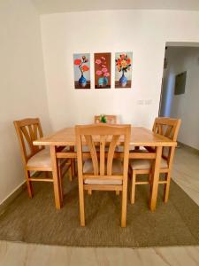 a wooden dining room table with four chairs at Cairo Madinty 2 in Madinaty