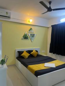 a bedroom with a bed with a ceiling fan at Luxurious 3bhk Apartments in Pune