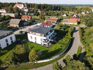 an aerial view of a large white house with a yard at Brisare in Göhren-Lebbin
