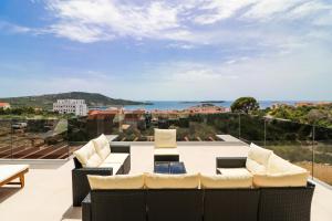 a balcony with furniture and a view of the ocean at Villa Golden Lion in Primošten