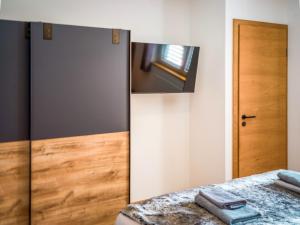 a bedroom with a mirror and a bed at ALTE MÜHLE LOFT - AlpenLuxus Collection in Brixlegg