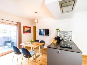 a kitchen and dining area with a table and chairs at ALTE MÜHLE LOFT - AlpenLuxus Collection in Brixlegg