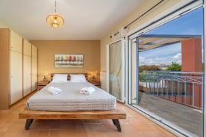 a bedroom with a bed and a balcony at Eglina Villa's in Minia +94 photos